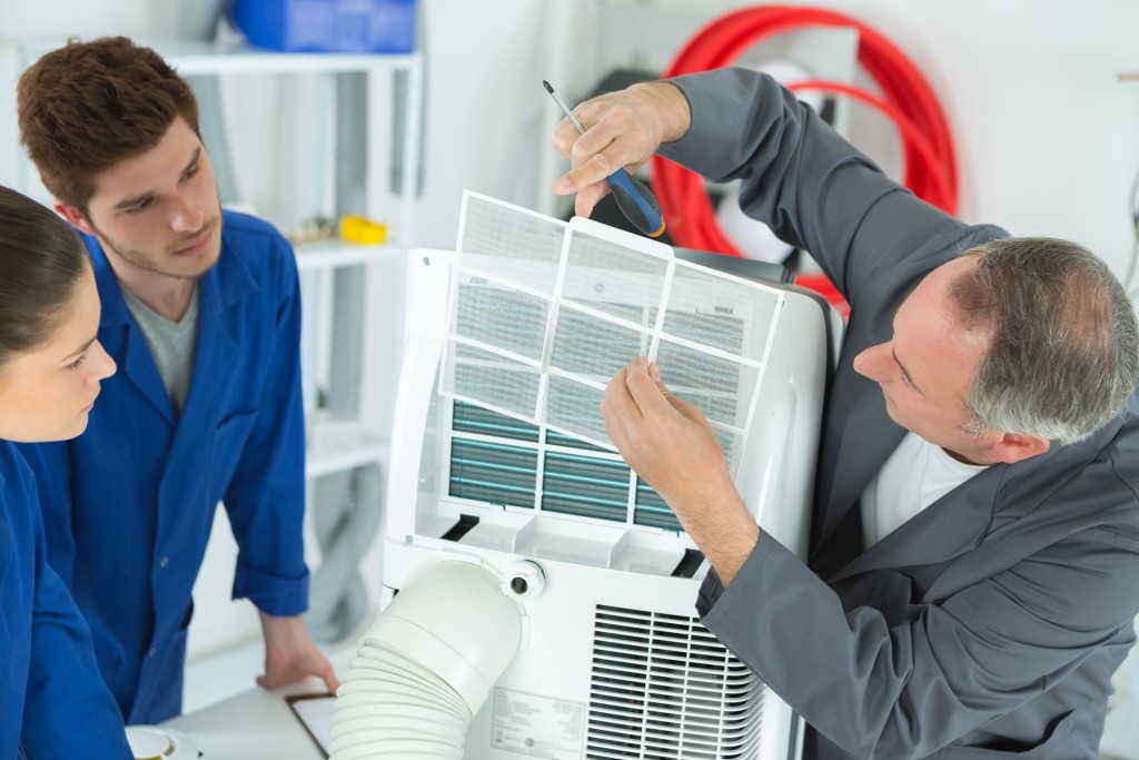 workers fixing aircon