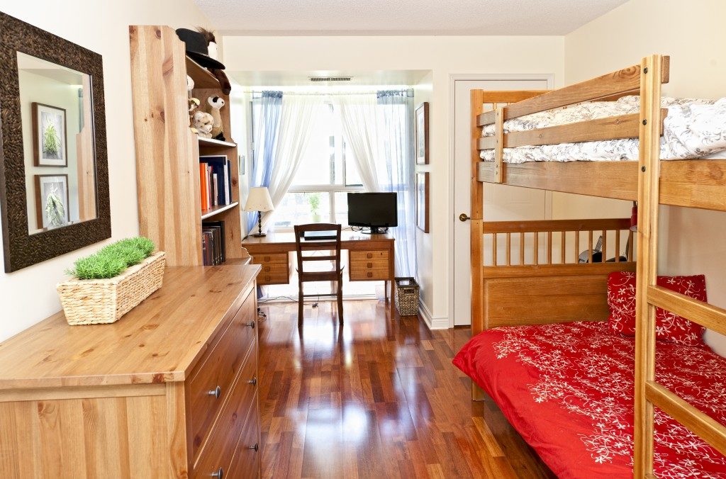 A bedroom with hardwood floors and bunk bed