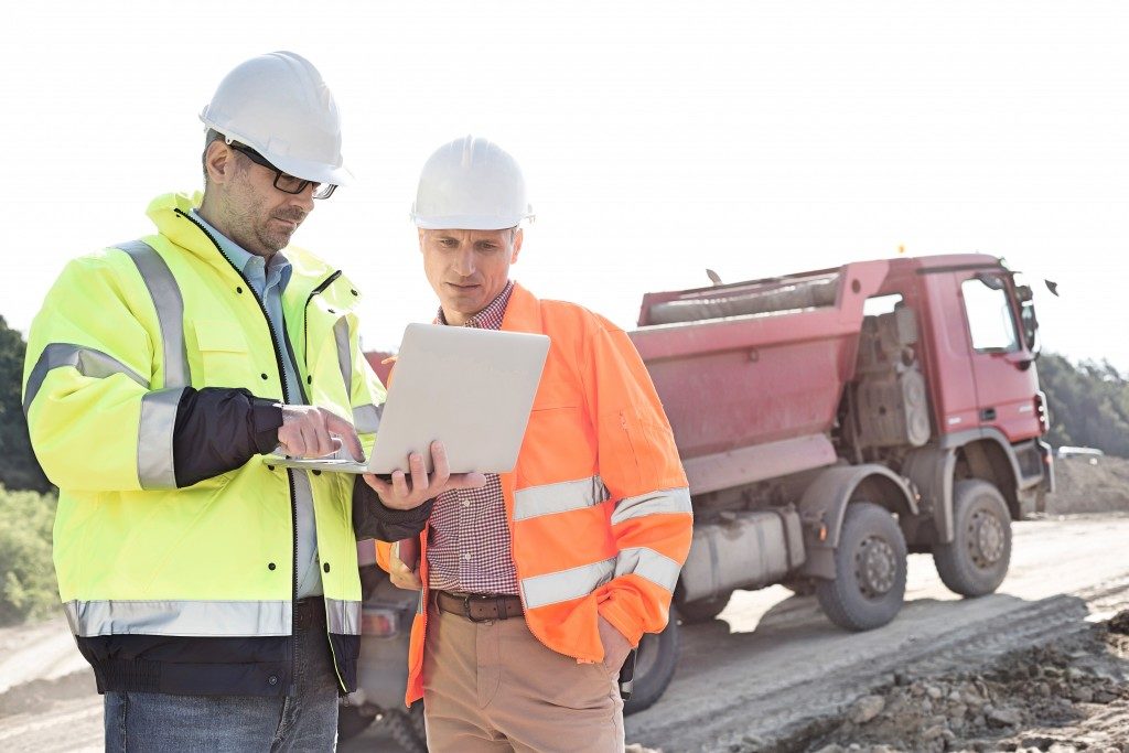 two men talking at a constuction site