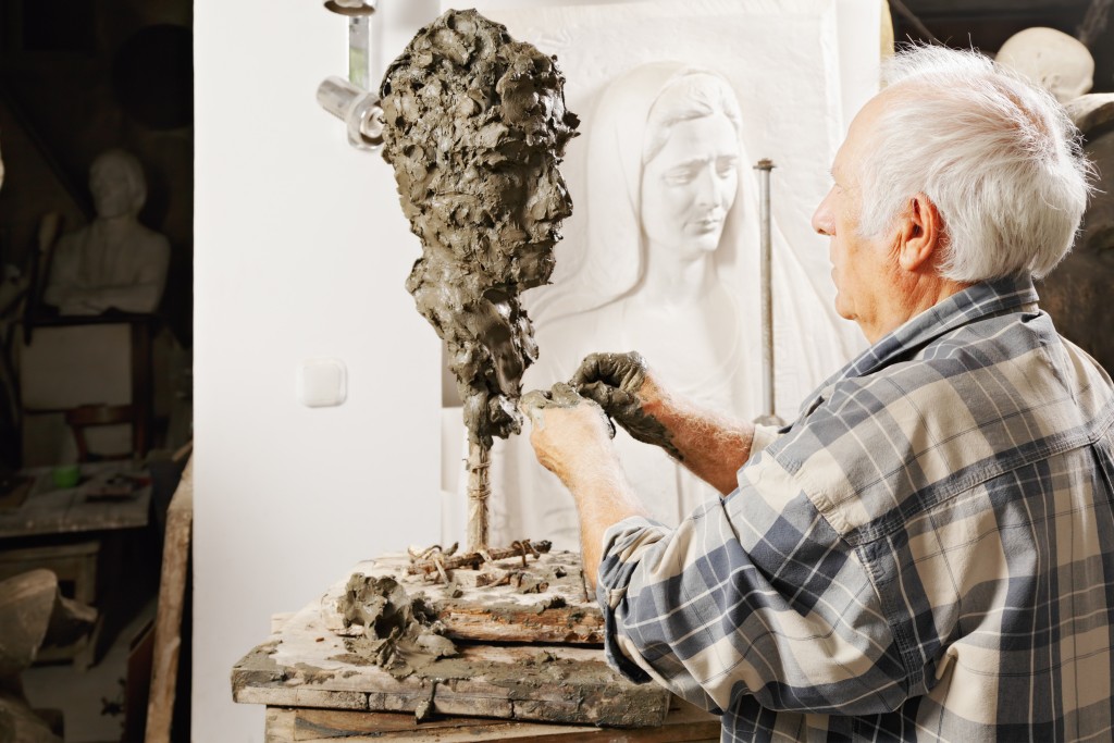 Man sculpting a bust