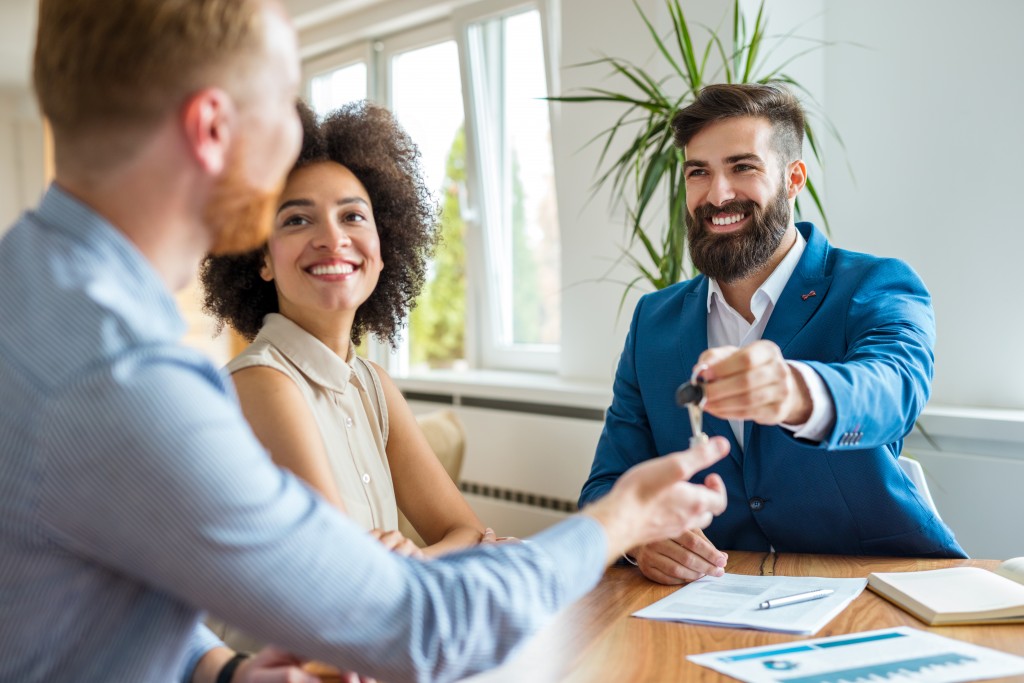 broker handing the home key to his client