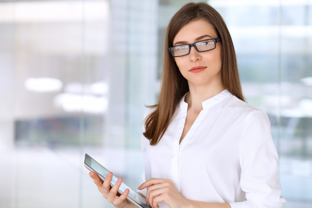 Woman in a business attire holding a tablet