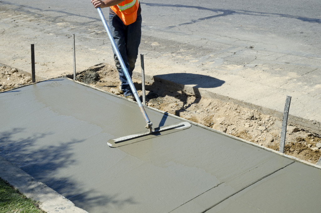 a person paving the concrete