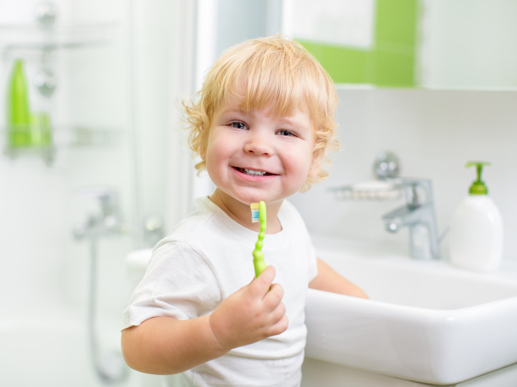 a kid holding a toothbrush