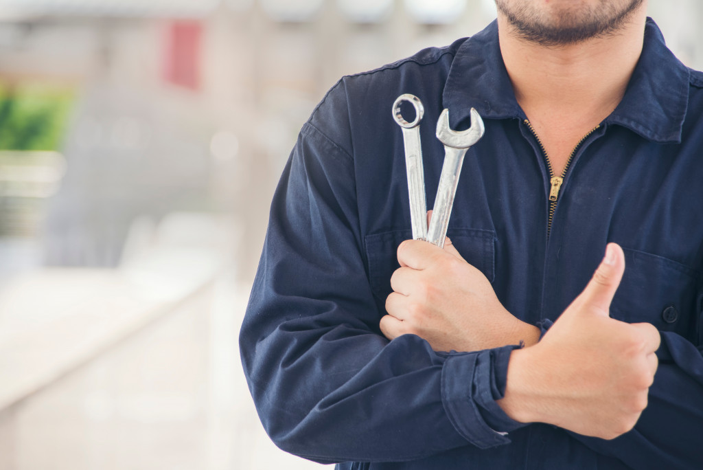 a car repairman with thumbs up