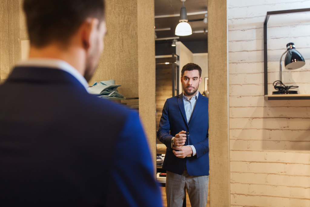 businessman dressing up in front of the mirror