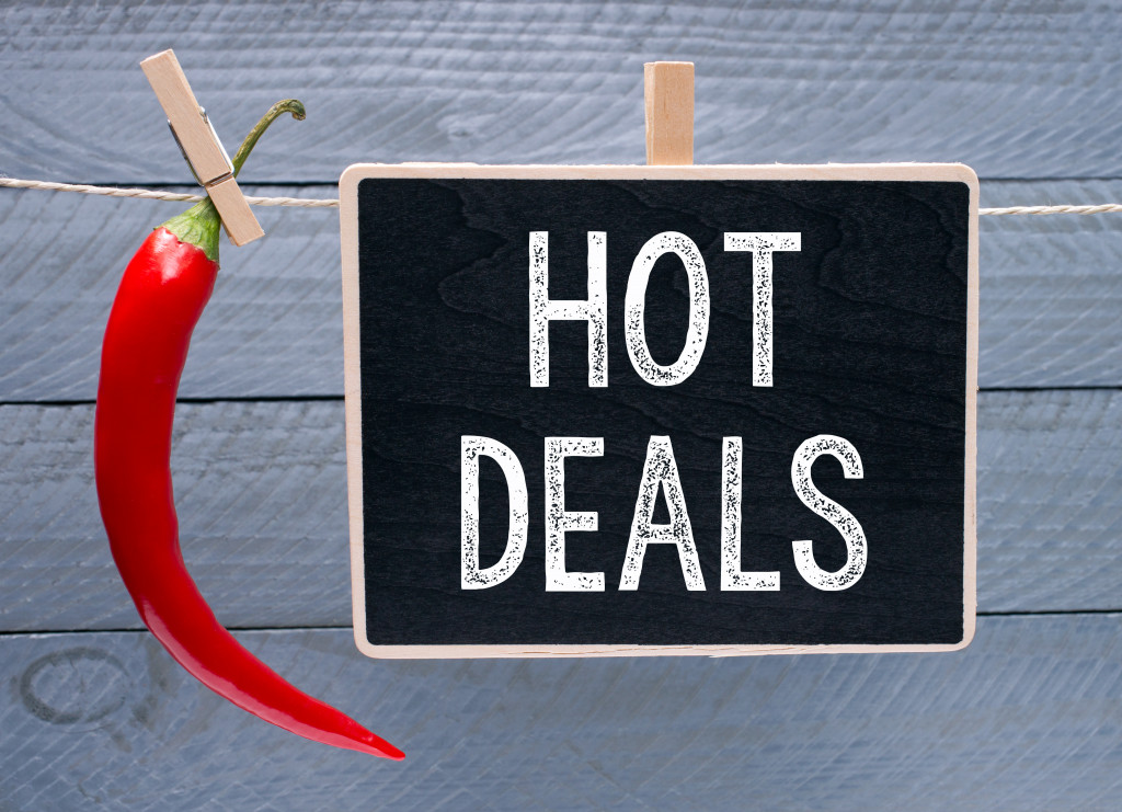 A chalkboard with the words HOT DEALS beside a chili