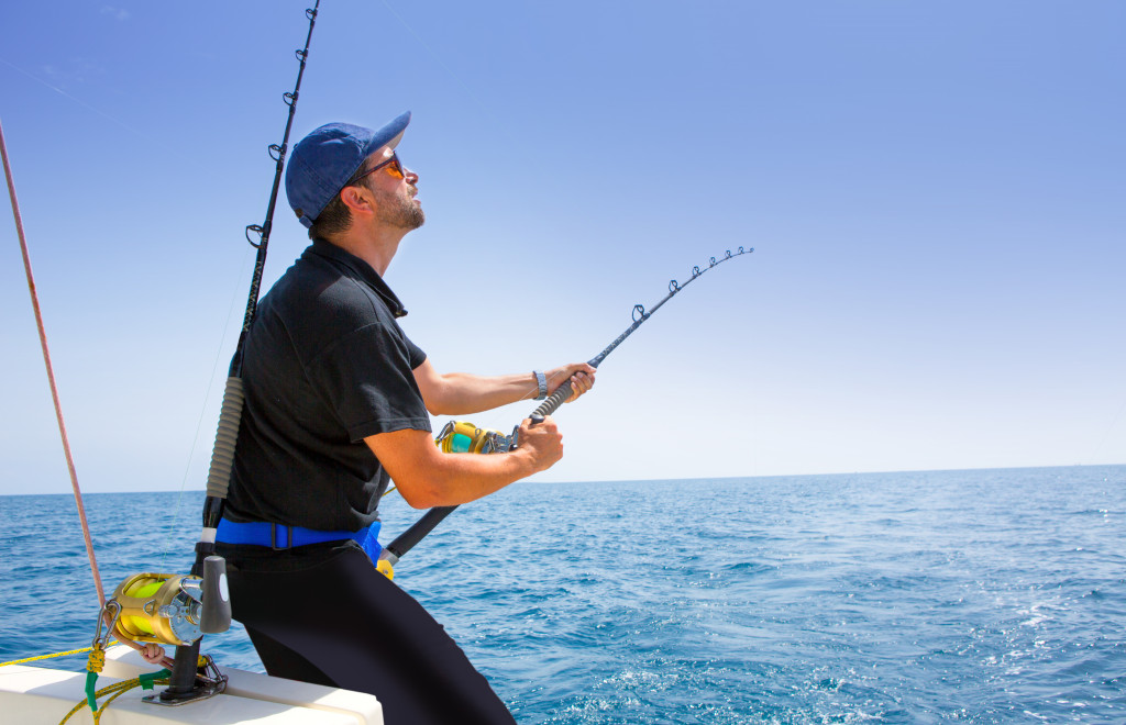 A tourist happily fishing at sea