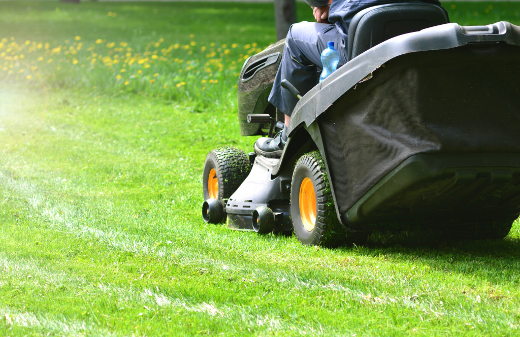 A person cutting grass using a lawnmower