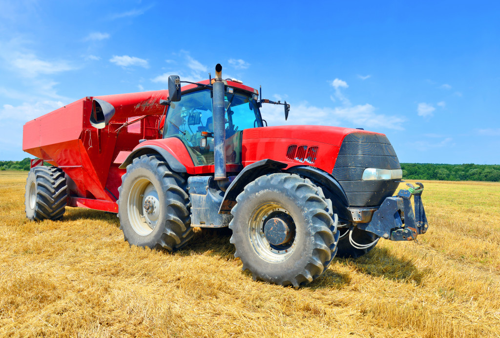 red farm equipment in a field outdoors