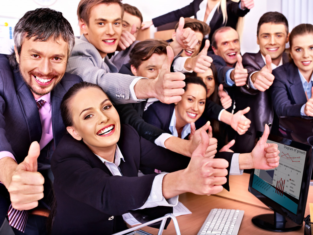 business people thumbs up