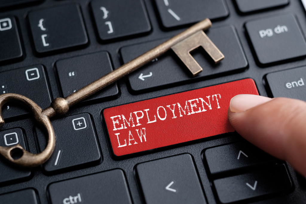 A red employment law key and a key on a keyboard