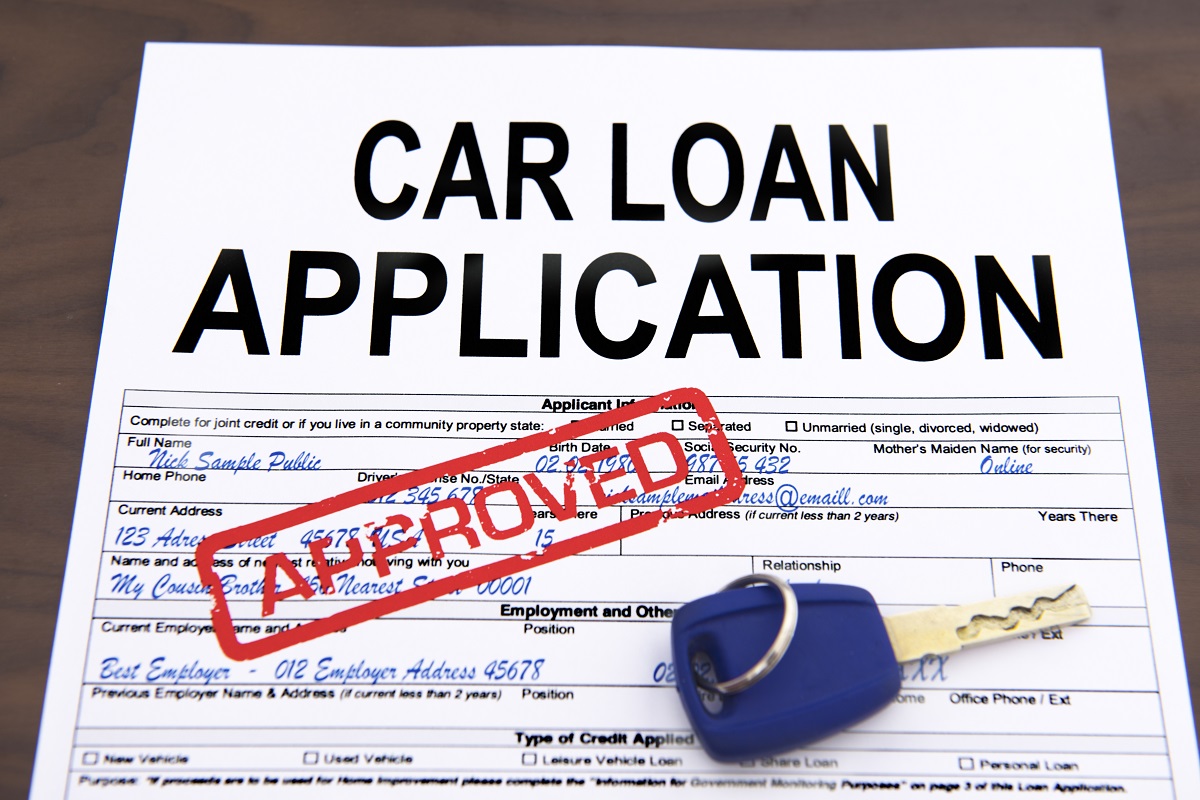 approved car loan application form and a key